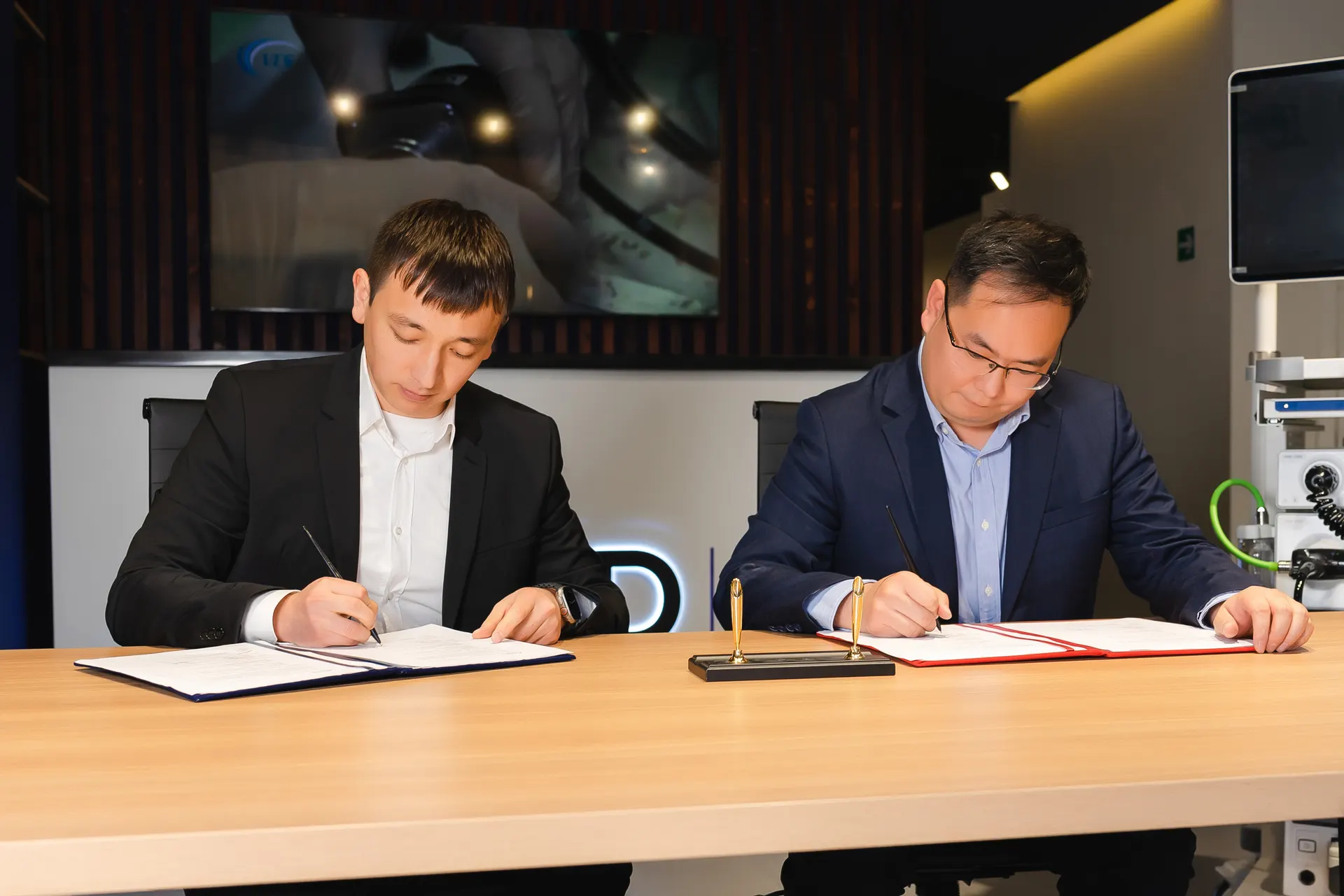 Q-Med — signing and presentation — frame 2